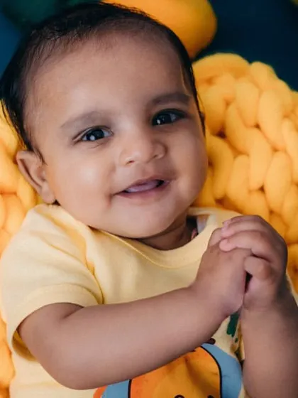 Such a sweet and gentle expression from this little one. The vibrant yellow and green colors really make his portrait pop.