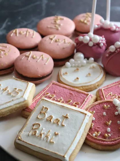 This shot highlights the personalized macarons with the couple's initials and the custom "Baat Pakki" cookies.
