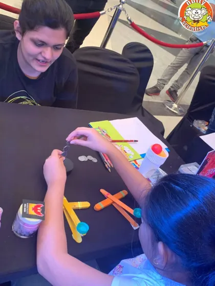 A mother and daughter work together to build a catapult. My workshops are designed to be fun for the whole family, encouraging teamwork and shared learning.