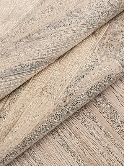 This close-up of a textured wallpaper with a brushed, wood-grain effect highlights the aesthetic appeal and design variety I offer. It's an easy and affordable way to update your space.