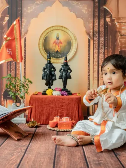 This image captures the baby's curiosity as he explores the props. The setup includes a Tulsi plant and idols of Vitthal Rukmini, adding authenticity to the Varkari theme.