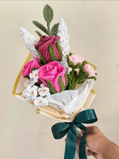 This romantic bouquet features two-toned pink crochet roses and smaller pink carnations, accented with white filler flowers. The soft colors and lush textures make it a perfect gift for someone special.