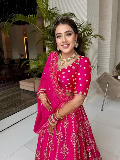 A vision in rani pink for her Godh Tikka ceremony. I created a soft smokey eye and a glowing base to complement her heirloom lehenga.