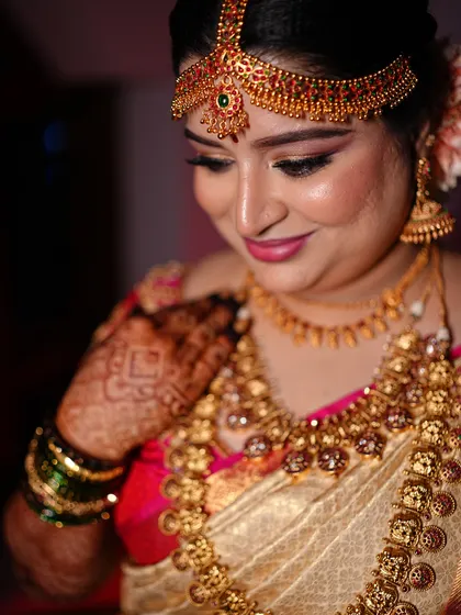 A candid, happy moment. The makeup enhances her features without masking her joyful expression.