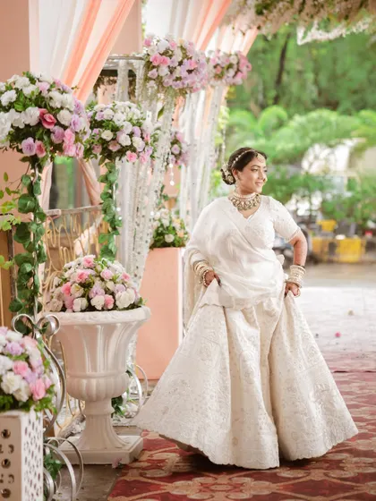 The bride looking elegant against a backdrop of beautiful floral decor. We use the venue's beauty to enhance our bridal portraits.