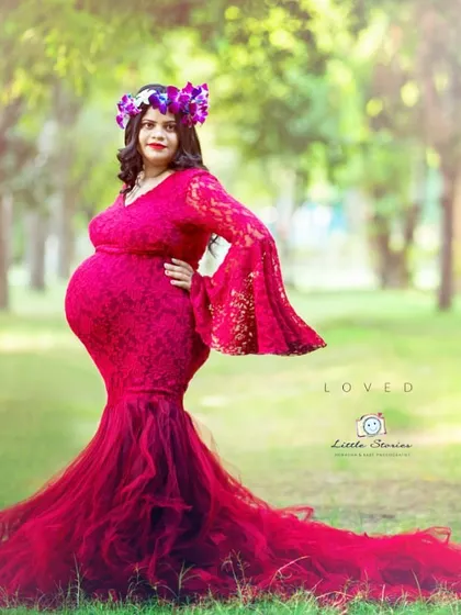 An outdoor setting provides the perfect canvas for a bold, statement-making portrait. The vibrant red of this gown stands out beautifully against the soft greens of the park.
