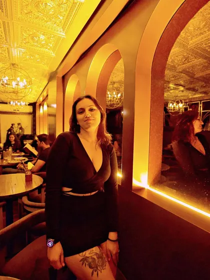 A guest enjoying the intimate and stylish atmosphere of the speakeasy.
