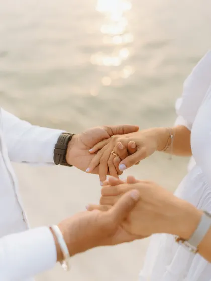 A close-up of hands, symbolizing connection and promise. This detail shot from a pre-wedding session adds a layer of depth to the couple's visual story.