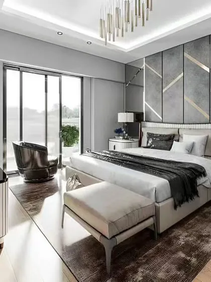A luxurious and modern bedroom with a grey and silver color scheme. The geometric-patterned accent wall and large sliding glass door to the balcony make the room feel spacious and sophisticated.