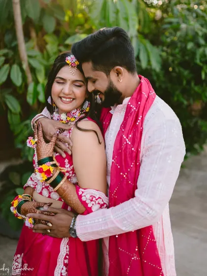 A happy, candid embrace between the couple during their Haldi ceremony.