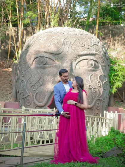 The couple shares a happy moment on a bridge, with the unique backdrop adding an artistic element to their outdoor maternity session.