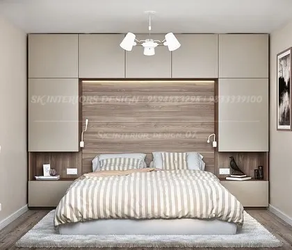 A practical and stylish bedroom design with storage cabinets built above and around the bed. The combination of beige laminate and a wood-finish headboard creates a warm and cozy atmosphere.