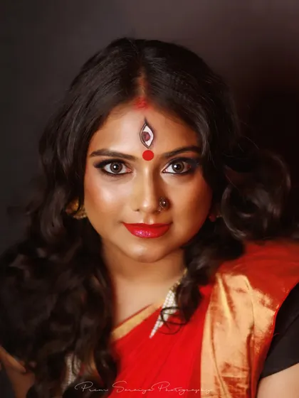 A direct and captivating portrait from the Devi shoot. This close-up highlights the clean lines of the eye makeup and the precise detail of the forehead art, set against a flawless, glowing complexion.