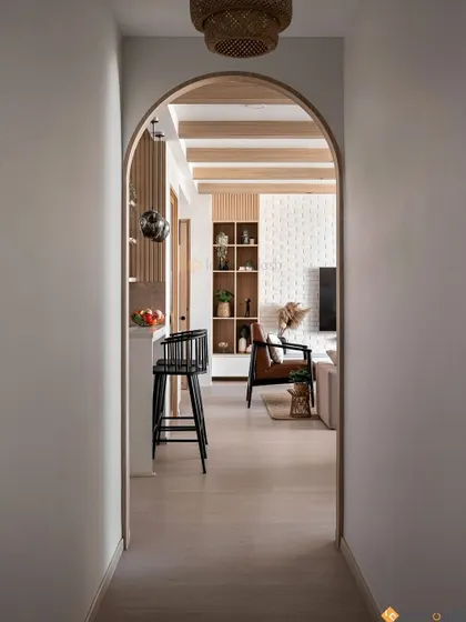 Looking through the arched doorway, you can see how the open layout connects the kitchen, dining, and living areas. This design is perfect for modern family living and entertaining.