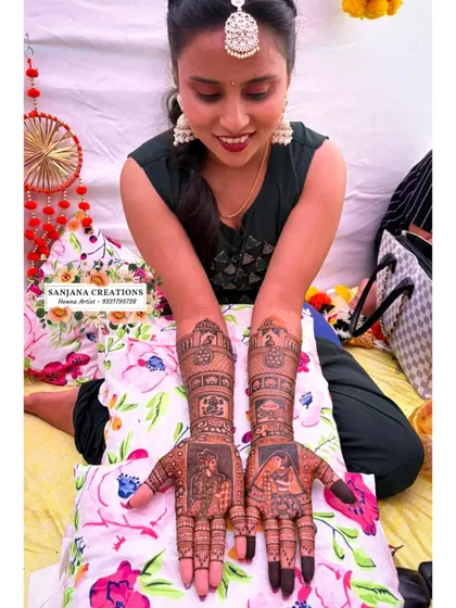 The bride admiring her completed mehndi, a beautiful start to her wedding celebrations.
