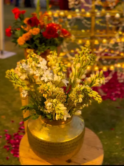 A traditional brass pot filled with fresh tuberoses, a simple yet elegant detail that adds a touch of heritage to any decor.