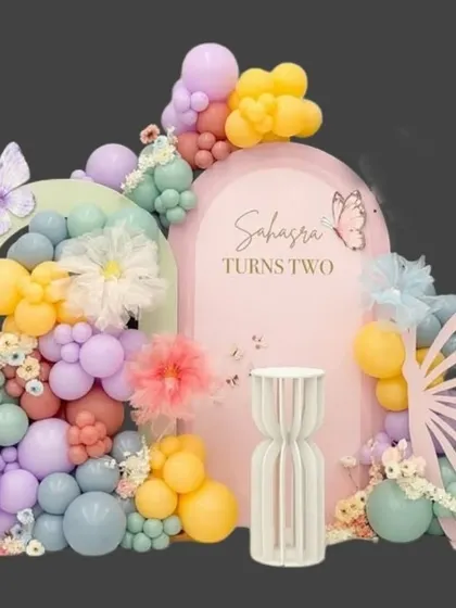 A beautiful butterfly theme for Sahasra's second birthday, using a pastel balloon palette, floral details, and elegant butterfly wing cutouts.