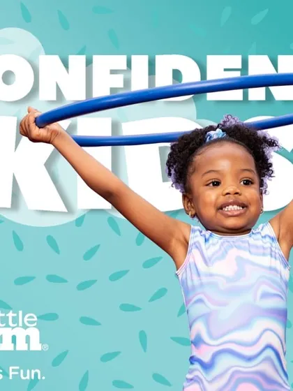 A confident kid is a happy kid. Holding a hula hoop high, this young gymnast is a perfect picture of the joy and self-assurance we aim to build in every class.