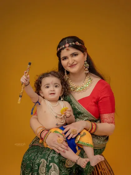 A playful shot of mother and child, where the baby, dressed as Krishna, holds up his flute. I provide all costumes for both mother and baby for this special session.