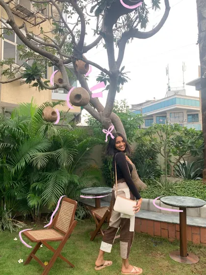 Enjoying the garden, with pink ribbons doodled around the trees for a whimsical touch.