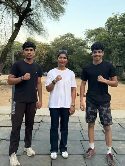 Two of our students with their coach. This picture captures the bond and mutual respect that defines our academy.