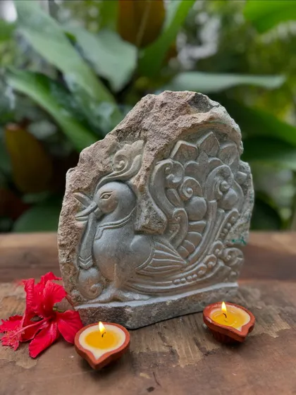 A beautiful stone carving of a Hamsa, or swan, with intricate plumage. The artist reveals the character from the stone with great care, creating a one-of-a-kind decor piece that brings charm and elegance.
