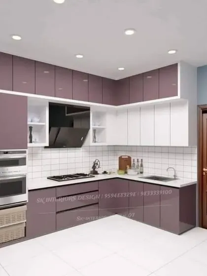A modular kitchen design with a striking combination of purple and white cabinets. The layout includes a tall unit for built-in ovens and practical wicker baskets for storage.