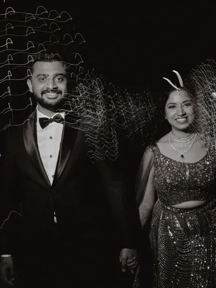 A black and white photo of the couple at their Sangeet, with creative light trails adding an artistic and dynamic feel.
