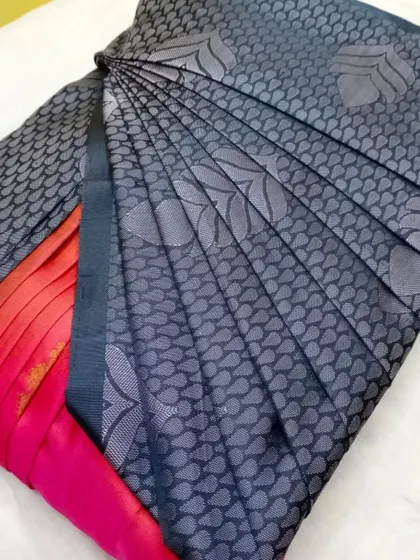 A beautiful grey saree with a red border. The pleats are done to highlight the unique pattern of the fabric.