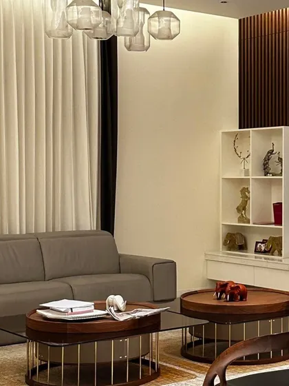A detail shot of a living room, highlighting the custom-designed coffee tables, curated decor, and the interplay of different textures and materials.