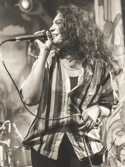 A portrait of our lead female vocalist, Dhruvi, in her element on stage. Her powerful voice can handle everything from rock anthems to soulful ballads.