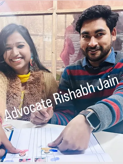 A smiling couple points to their details on the marriage register, a happy conclusion to their legal formalities. I assist with love marriages and provide all necessary legal services in Delhi.