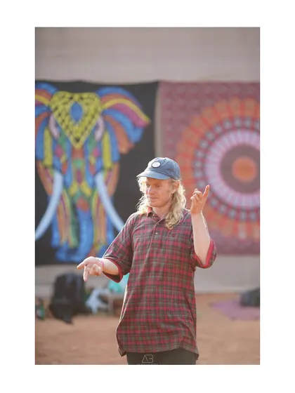 A candid shot of a man in the middle of a dance or conversation, capturing the natural and unposed vibe of the festival.