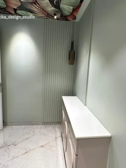 This angle shows the main door of the home, which features a similar rounded detail, creating a cohesive design language that flows through the entryway.