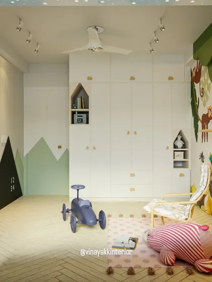 The full view of this "tiny dreamland" shows how we combine different elements. A whimsical wall mural, a mountain-shaped chalkboard, and a tree-like coat rack all contribute to a room that encourages creative play.