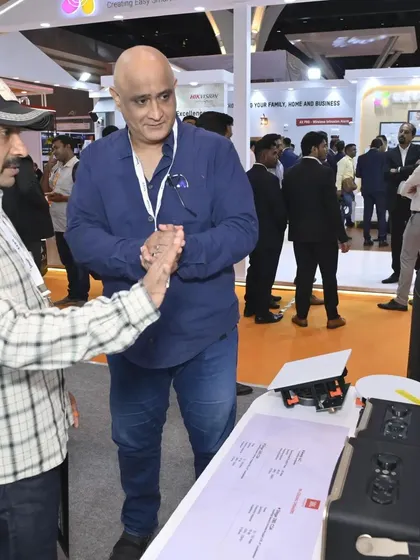 An engaged visitor exploring our portable and professional audio solutions at the expo. We cater to a wide range of needs, from large installations to smaller, high-quality systems.