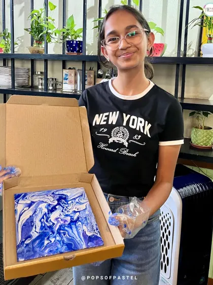 The stunning blue and white patterns on this canvas show how different color combinations can create completely different moods in fluid art.