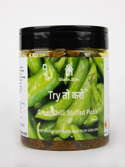 A jar of Green Chilli Stuffed Pickle on a white background.