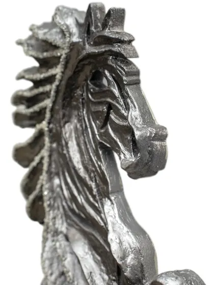 A close-up view of the head of "The Rising Horse," showing the intricate textures and embedded diamonds that give it life.