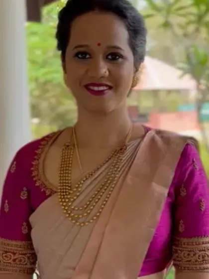 A closer look at the intricate handwork on this magenta raw silk blouse. The detailed embroidery along the U-shaped neckline and sleeves adds a sophisticated touch, making it a perfect pairing for a classic silk saree.