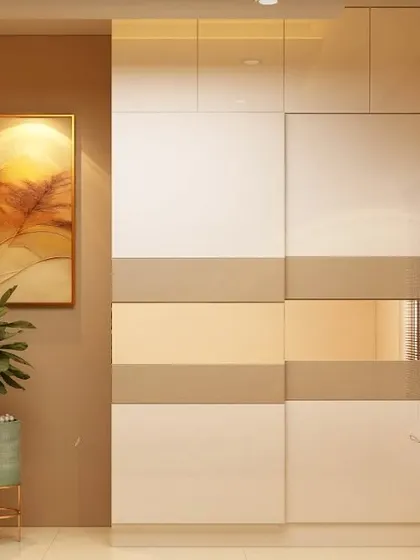A minimalist sliding wardrobe with a clean, two-tone design. The combination of glossy white and beige panels creates a subtle and sophisticated look that complements any modern bedroom.