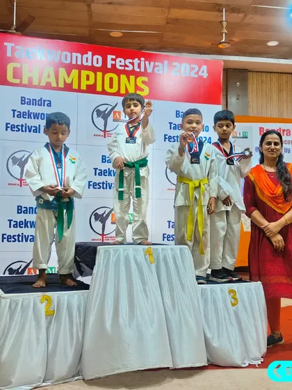 The next generation of champions. Our youngest fighters proudly display their medals on the podium at the Bandra Taekwondo Festival.