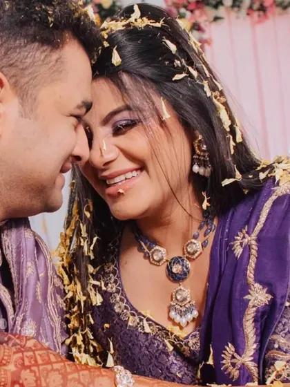 A beautiful, candid moment from the Haldi ceremony, with the couple sharing a laugh as they are showered with flower petals.