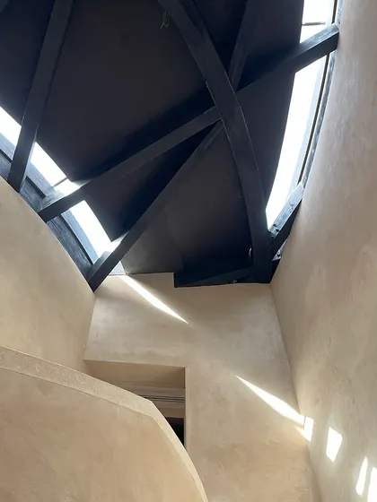 The dance of light and shadow from the skylights and timber rafters. This image captures the atmospheric quality we strive for, where the building itself becomes a canvas for the changing light of the day.