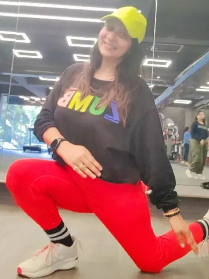 A deep lunge stretch, showing the flexibility and strength that comes with consistent practice. This is what it means to be a proud Zumba instructor.