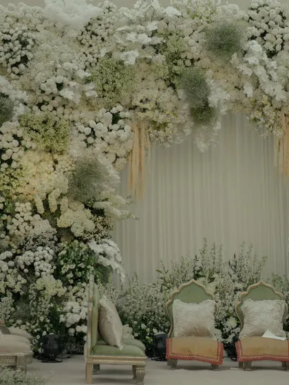A closer look at the mandap's floral arch, where I used a mix of textures with different white flowers and dried pampas grass for a soft, ethereal effect.