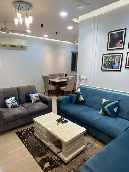 In this project, the client wanted a comfortable and classic living room. I paired plush sofas in blue and grey with a simple, elegant wall molding detail. The white marble-top coffee table adds a touch of luxury while providing practical storage drawers.