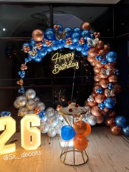 A wider view of the 26th birthday decor, showcasing the full arrangement against a large window for a dramatic nighttime effect.