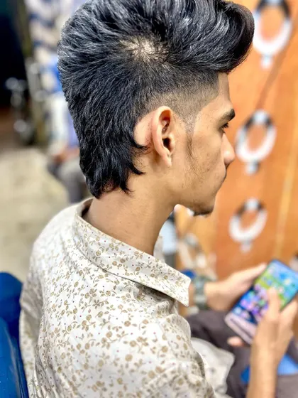 This mullet has a more subtle fade and a natural texture. It's a great option for someone wanting to try the style without a dramatic change.