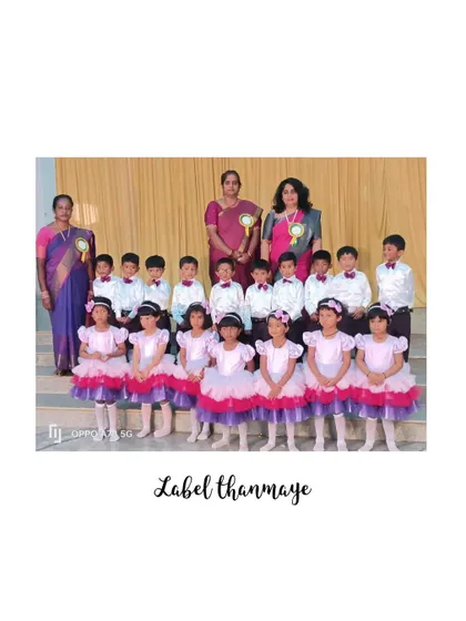The full group of performers in their pink and purple tutus and formal shirts, ready for their annual day event.